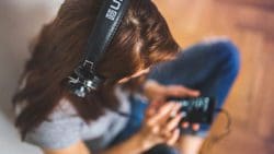 Woman listens to playlist to relieve stress from quitting smoking.