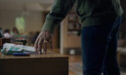 A man with a pack of smokes on his table