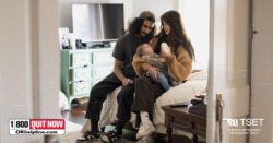 A young couple sitting on a bed together bottle-feeding their baby, with text overlaid reading Free Services To Help You Quit Tobacco, alongside the Oklahoma Tobacco Helpline 1-800-QUIT-NOW logo and TSET program badge.